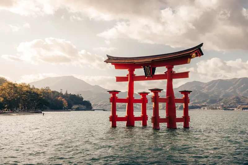The red torii gate of Itsukushima Shrine standing in the sea at Miyajima